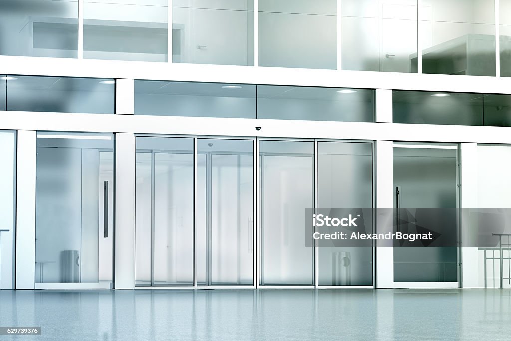 Blank commercial building glass entrance mockup Blank commercial building glass entrance mockup, 3d rendering. Business canter closed entry mock up. City bank exterior outdoor template. Corporation facade architecture, front view. Sliding Door Stock Photo