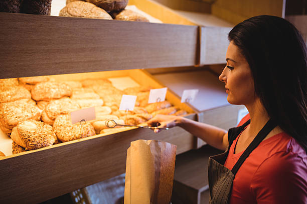 istock Female baker packing sweet food 629742010