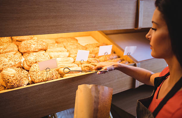 istock Female baker packing sweet food 629742116