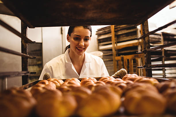 istock Female baker holding a tray of michetta 629742722