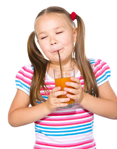 istock Little girl is drinking carrot juice 629743214