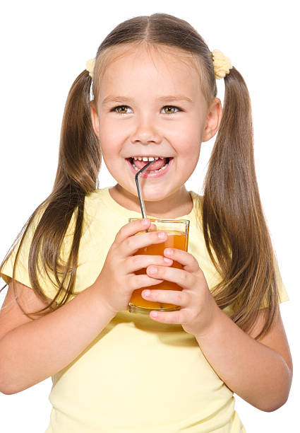 istock Little girl is drinking carrot juice 629743626