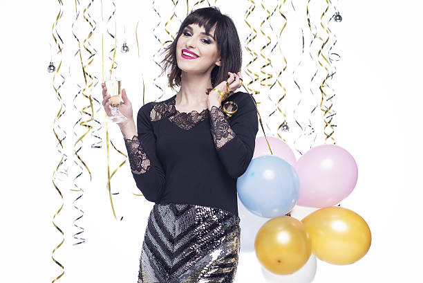 istock Beautiful woman elegantly dressed while having fun drinking champagne 629744206