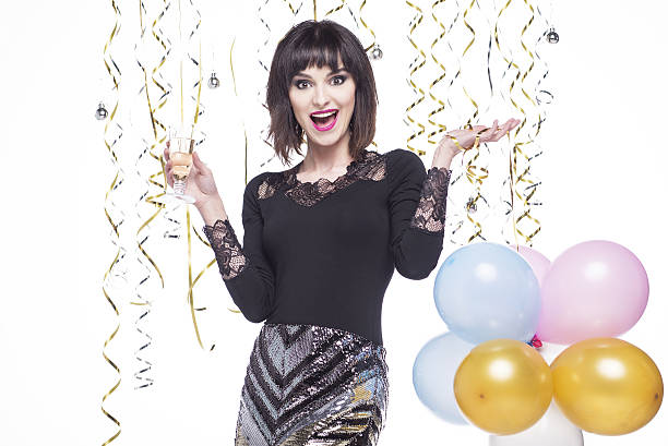 istock Beautiful woman elegantly dressed while having fun drinking champagne 629744290