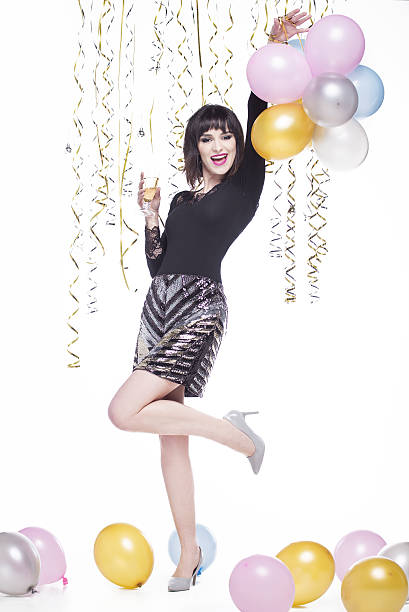 istock Beautiful woman elegantly dressed while having fun drinking champagne 629744486