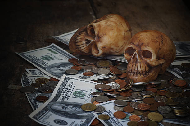 istock skull on bank note and coin 629744784