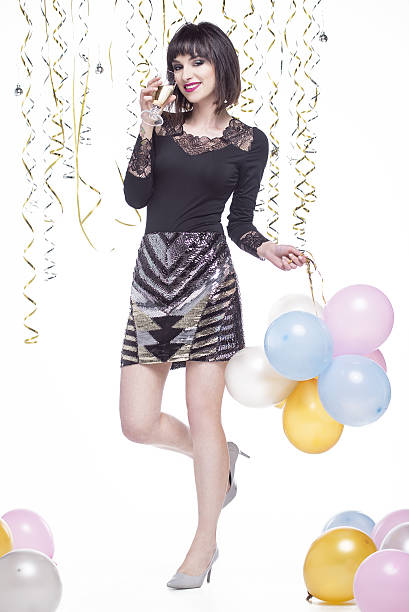 istock Beautiful woman elegantly dressed while having fun drinking champagne 629744968