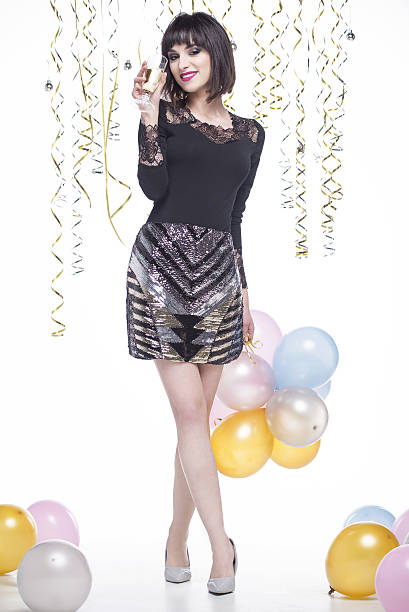 istock Beautiful woman elegantly dressed while having fun drinking champagne 629745182