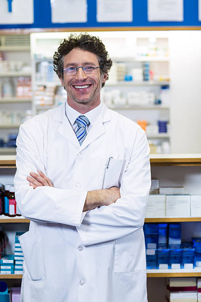 istock Pharmacist standing with arms crossed in pharmacy 629745922