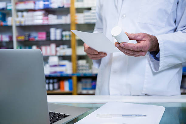 istock Pharmacist holding a prescription and medicine 629757238