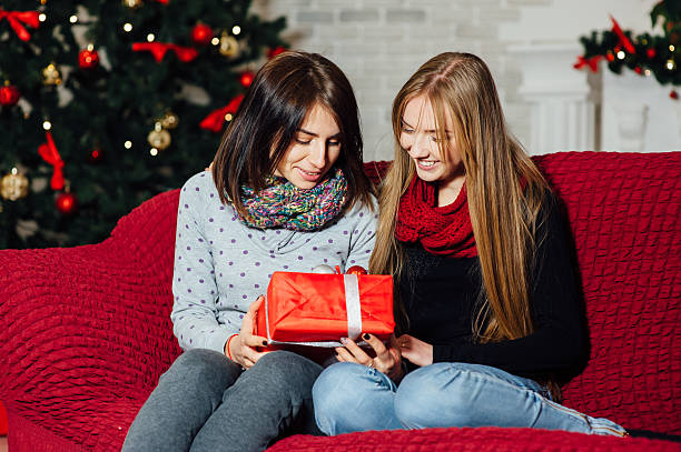 istock young beautiful girls sitting on a couch with 629757342