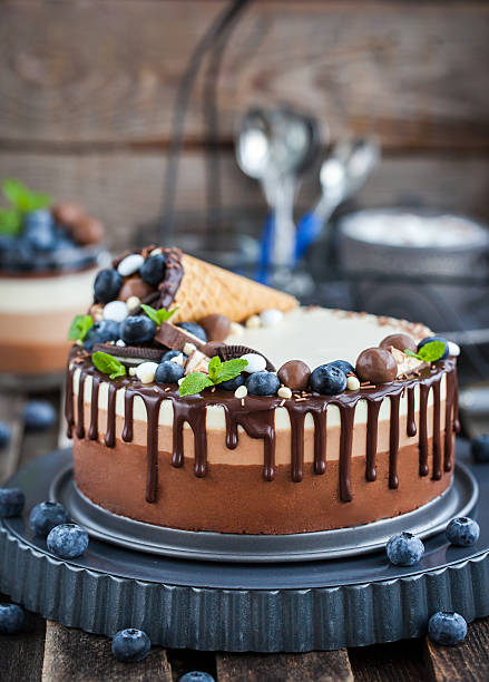 istock Three chocolate mousse cake decorated with waffle cone, fresh bl 629759760