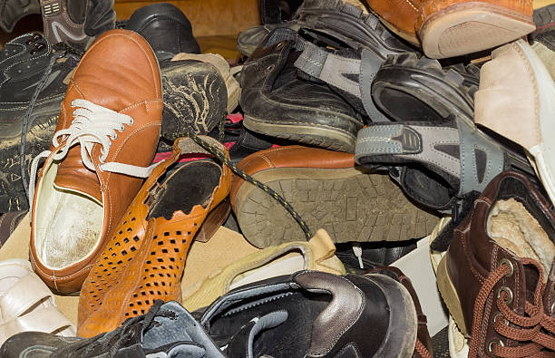 istock Pile of old different worn footwear 629760078