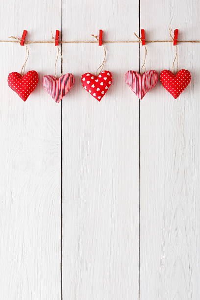 istock Valentine day background, pillow hearts border on wood, copy space 629760724