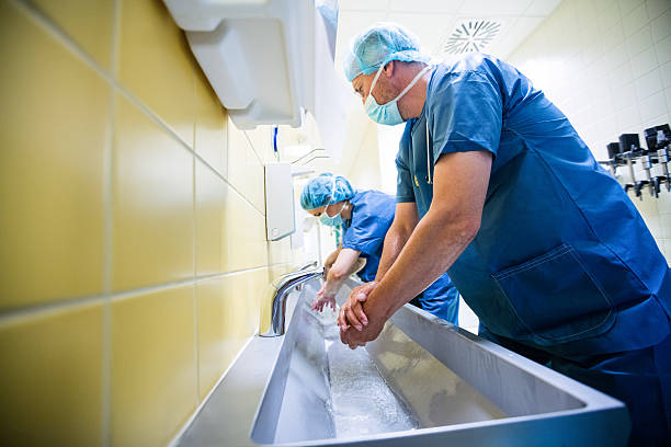 istock Group of surgeons washing their hands at washbasin 629761748