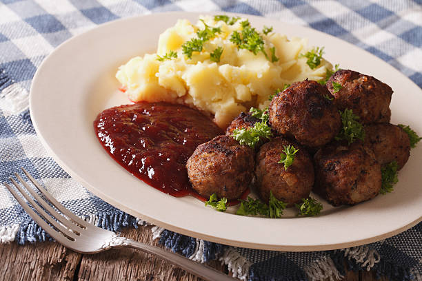 istock Swedish food: meatballs, lingonberry sauce with potato garnish. 629762424