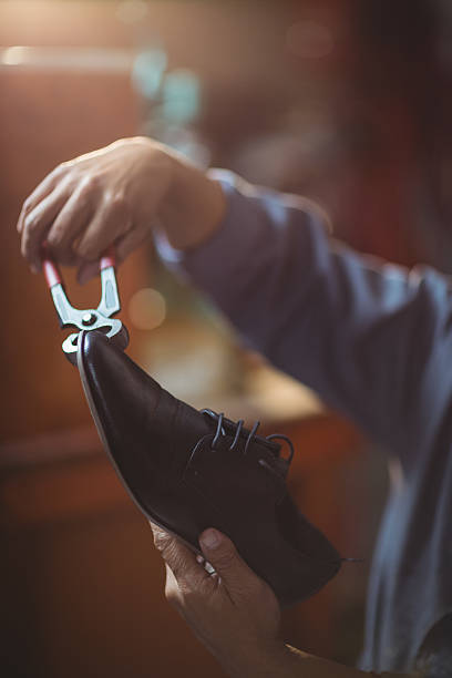 istock Shoemaker repairing a shoe 629763962