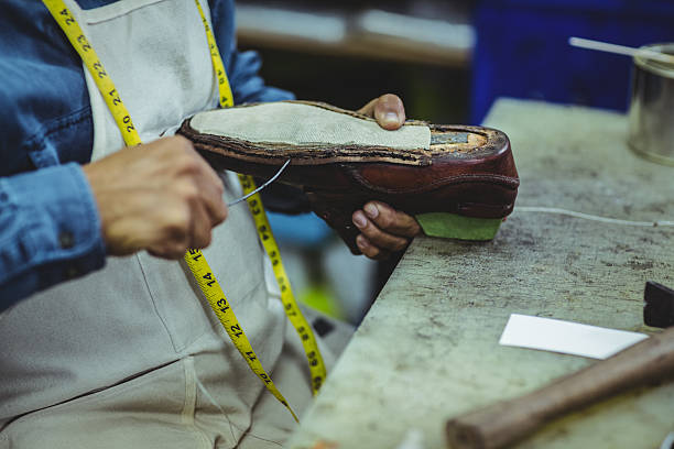 istock Shoemaker repairing a shoe 629764426