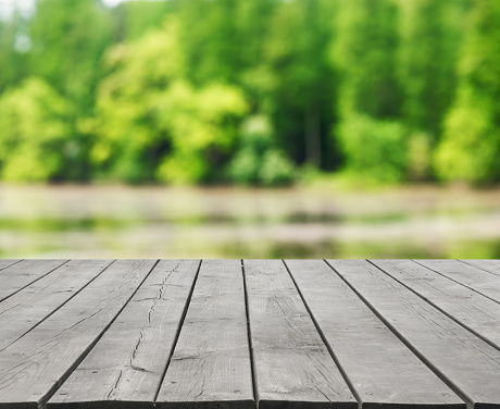 Empty wooden platform and green nature abstract background
