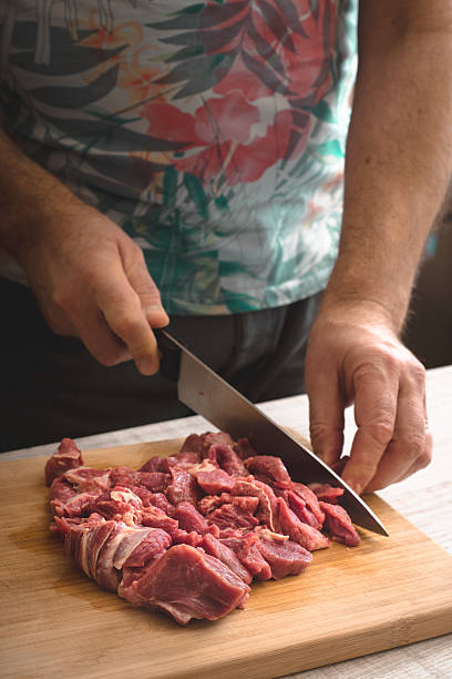 istock Cutting raw meat on the wooden board vertical 629765880