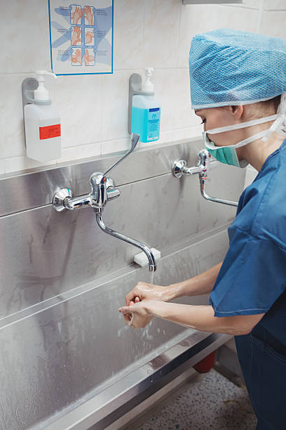 istock Female surgeon washing her hands 629766072