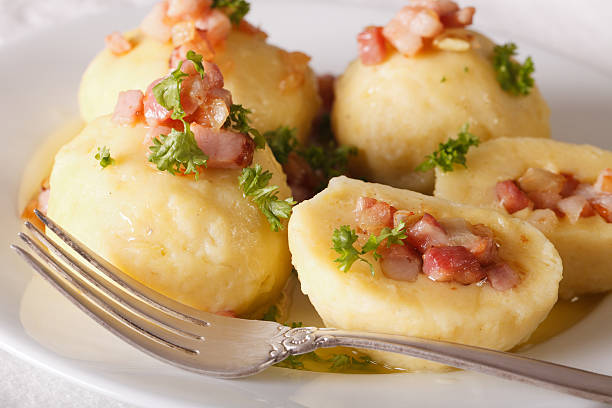 istock Potato dumplings stuffed with ham, bacon and onion close-up 629766074