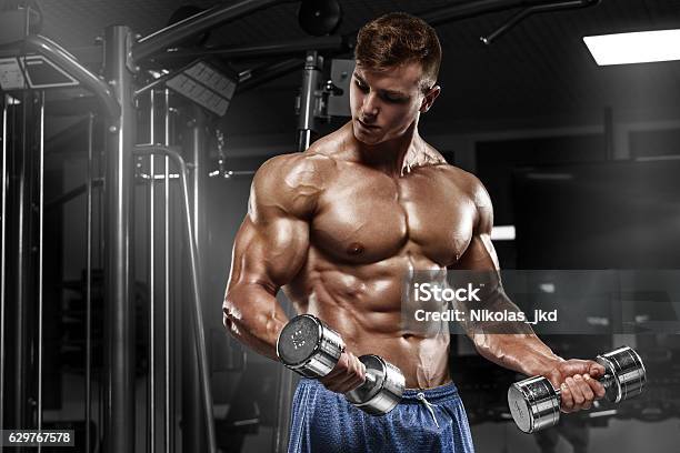 Muscular Man Working Out In Gym Doing Exercises Torso Abs Stock Photo - Download Image Now