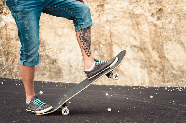 istock Closeup of skateboarder legs 629767624