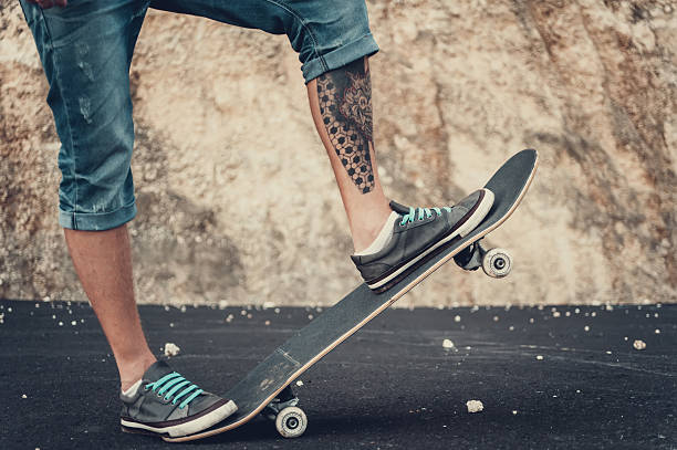 istock Closeup of skateboarder legs 629767738