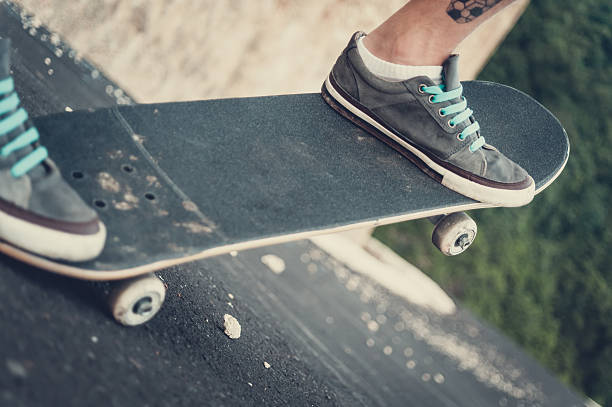 istock Close up of a skateboarders feet while skating 629767870