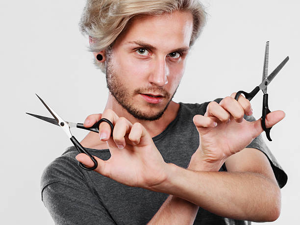 istock Man with scissors for haircutting 629768624