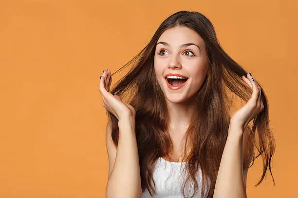 Photo of Surprised happy beautiful woman looking sideways in excitement, isolated