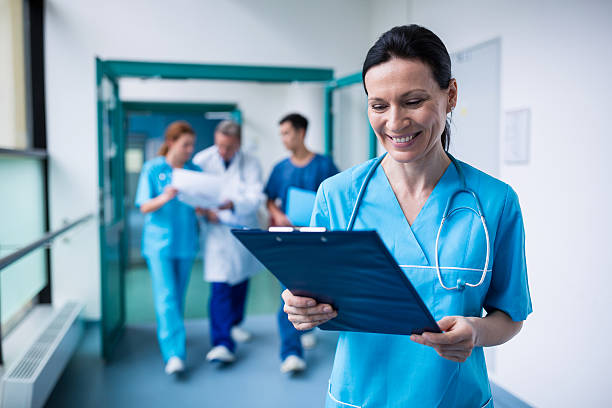 istock Smiling surgeon holding a clipboard at hospital 629772198