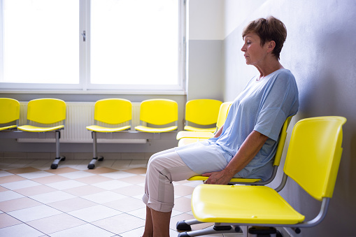 Patient sitting in a waiting room of a hospital