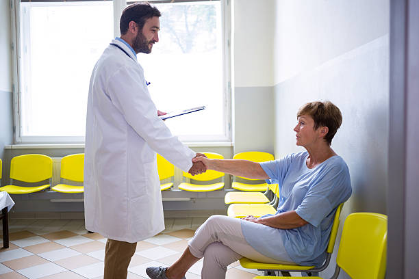 istock Doctor shaking hand with patient in waiting room 629772404