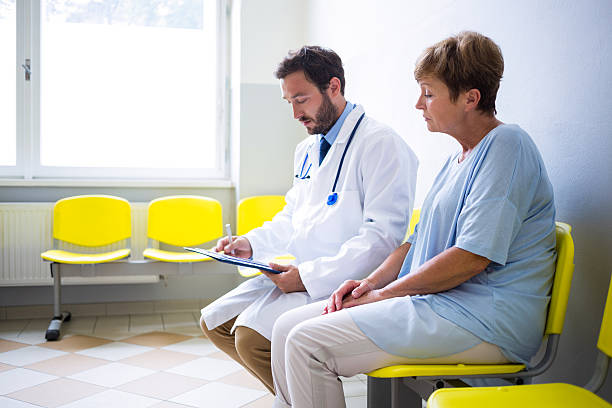 istock Doctor consulting patient in waiting room 629772420