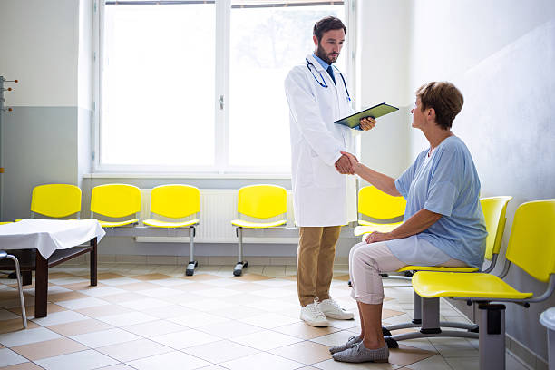 istock Doctor shaking hand with patient in waiting room 629772442