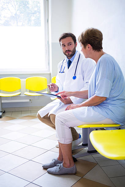 istock Doctor consulting patient in waiting room 629772464