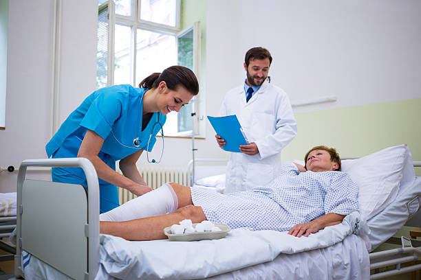 istock Nurse bandaging leg of patient 629774002