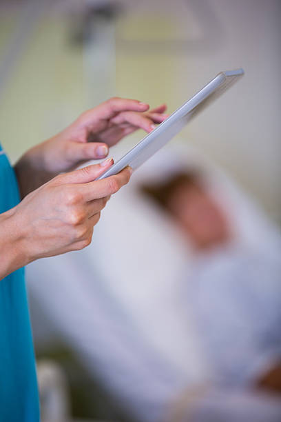 istock Nurse using digital tablet in hospital ward 629774278