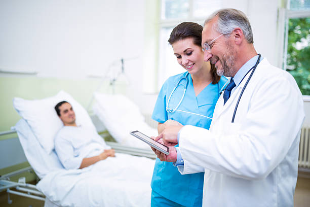 istock Doctor and nurse discussing on digital tablet 629774554