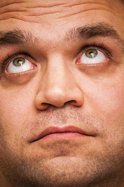 istock Looking up man. Facial expression, emoji face, emotion close-up. 629774930