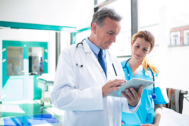 istock Doctor and nurse discussing over digital tablet 629774960