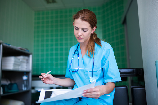 Nurse checking medical report at the hospital