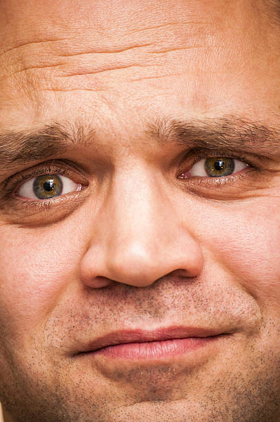 istock Sorrowful, sad, squinting man. Facial expression, emoji face, emotion close-up. 629775586