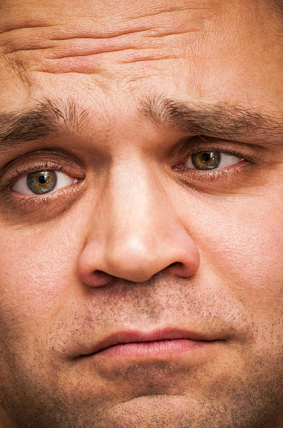 istock Depressed, sad, squinting man. Facial expression, emoji face, emotion close-up. 629775668