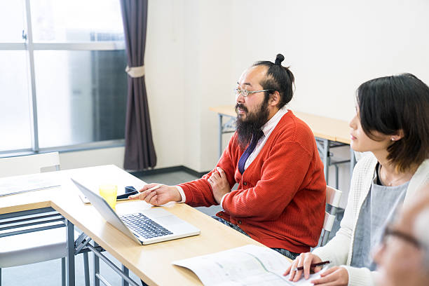 adults students at a training seminar or further education classroom - mature student learning training computer imagens e fotografias de stock