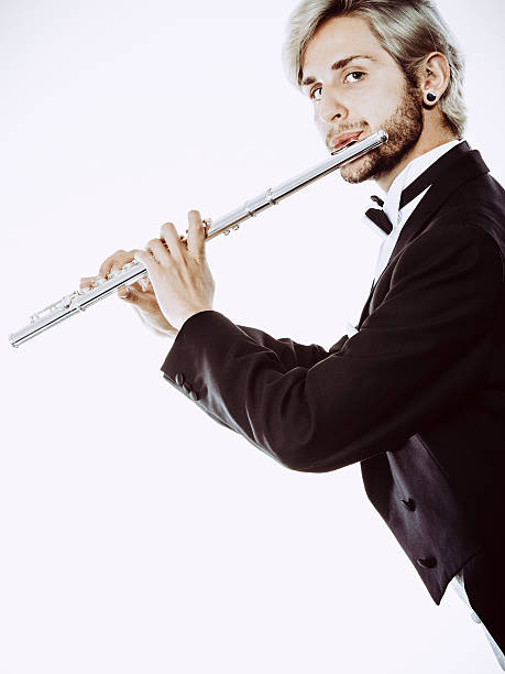 istock Male flutist wearing tailcoat plays flute 629776412