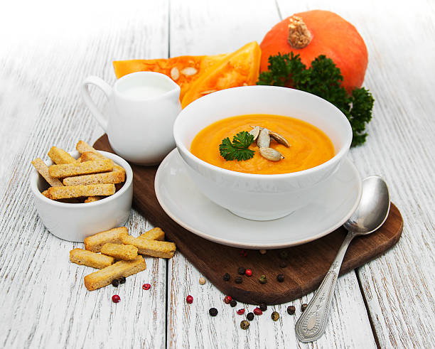 istock Pumpkin soup with fresh pumpkins 629776520