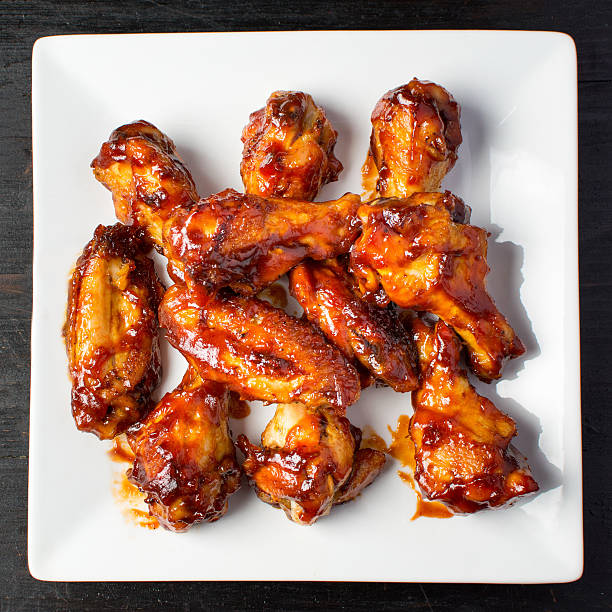 istock Baked chicken wings on a white plate 629777036
